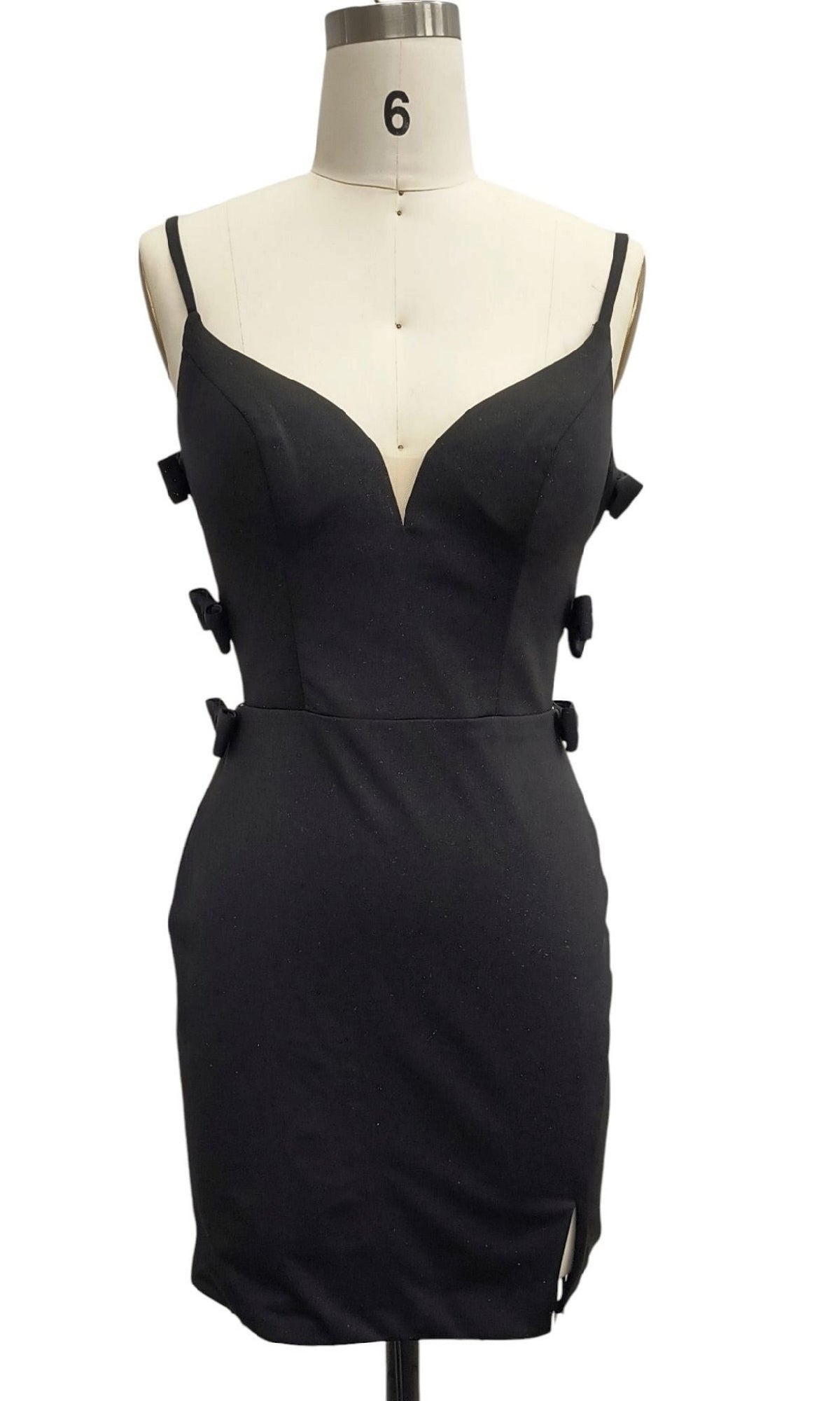 The Backless Black Hoco Dress: 12387 features a fitted bodice, deep V neckline, side bows, and a mini skirt with a slit—a designer homecoming dress and the ideal little black cocktail dress for special nights.